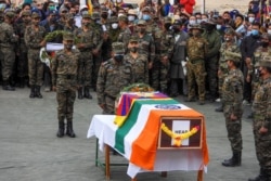 FILE - Indian soldiers pay their respects during the funeral of their comrade, Tibetan-origin India's special forces soldier Nyima Tenzin, in Leh on Sept. 7, 2020.