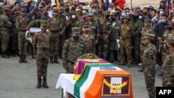 FILE - Indian soldiers pay their respects during the funeral of their comrade, Tibetan-origin India's special forces soldier Nyima Tenzin, in Leh on Sept. 7, 2020. 