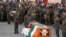 FILE - Indian soldiers pay their respects during the funeral of their comrade, Tibetan-origin India's special forces soldier Nyima Tenzin, in Leh on Sept. 7, 2020. 