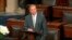 In this image from Senate Television, Sen. Lindsey Graham, R-S.C., speaks on the Senate floor at the Capitol in Washington, Aug. 28, 2018, next to the desk of Sen. John McCain, R-Ariz., draped in black with a bowl of white roses sitting on it.