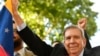 Venezuelan opposition leader Edmundo Gonzalez Urrutia holds a Venezuelan flag as he greets supporters after a meeting with Uruguay's President Luis Lacalle Pou in Montevideo, Uruguay, Jan. 4, 2025.