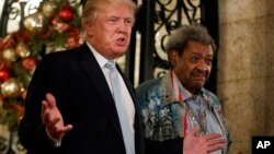  President-elect Donald Trump (left) stands with boxing promoter Don King as he speaks to reporters at Mar-a-Lago, Dec. 28, 2016, in Palm Beach, Fla.