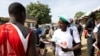 FILE - A member of the Consultation Group Of Political Actors (GCAP) distributes flyers at Dembe market promoting the boycott of Chad's legislative, communal and provincial elections in N'Djamena on Dec. 16, 2024.