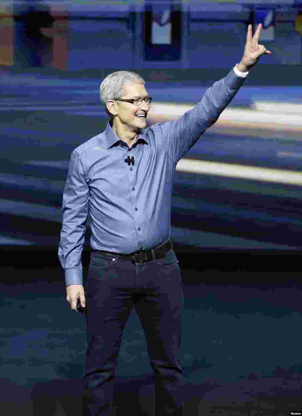 Apple CEO Tim Cook greets the crowd during an Apple media event in San Francisco, California.