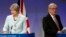 British Prime Minister Theresa May, left, and European Commission President Jean-Claude Juncker prepare to address a media conference at EU headquarters in Brussels on Dec. 8, 2017. 