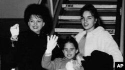 Judy Garland, background, left, waves with her children, Liza, 15, top right, Lorna, 9, center, and Joe, 6, on Jan. 2, 1962, as they were about to board a plane at New York International Airport