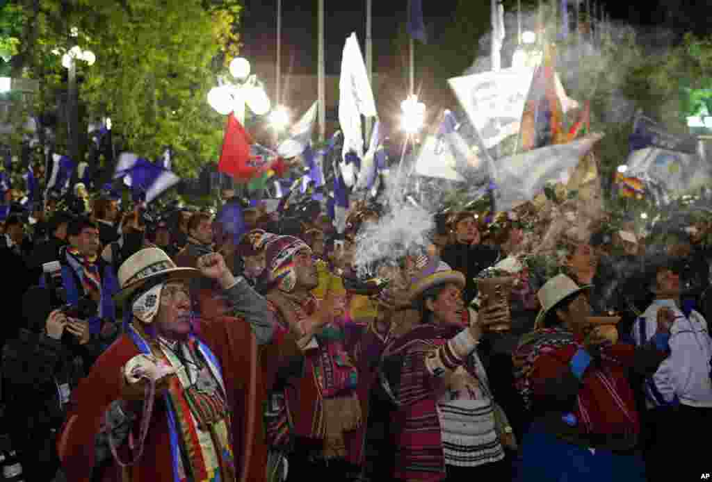 Aymara indigenous and other supporters cheer President Evo Morales as he speaks from the balcony of the presidential palace in La Paz, Oct. 12, 2014.