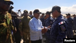 Leslie Voltaire, president of Haiti's transition council, welcomes a military contingent from El Salvador, at the Toussaint Louverture International Airport, in Port-au-Prince, Haiti, Feb. 4, 2025. 