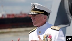 FILE - Admiral Craig Faller, commander of U.S. Southern Command, speaks with reporters following a commissioning ceremony for the U.S. Navy's guided missile destroyer, the USS Paul Ignatius, at Port Everglades in Fort Lauderdale, Fla., July 27, 2019.