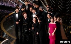 Kwak Sin Ae and Bong Joon-ho win the Oscar for Best Picture for "Parasite" at the 92nd Academy Awards in Los Angeles, Calif., Feb. 9, 2020.
