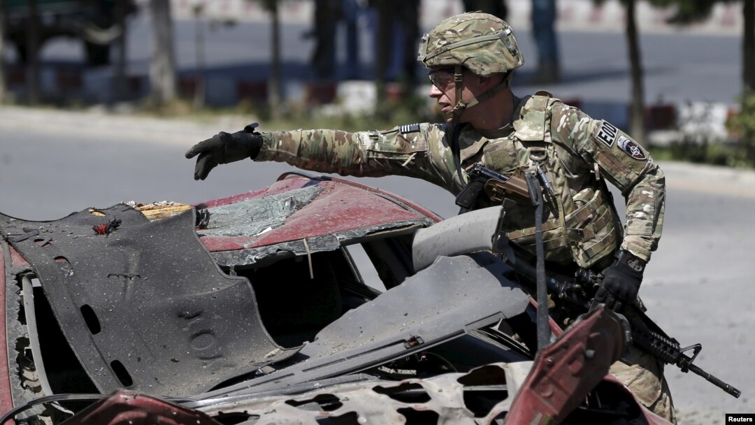 A U.S. soldier inspects the site of a suicide bomb attack in Kabul, Afghanistan, June 30, 2015.