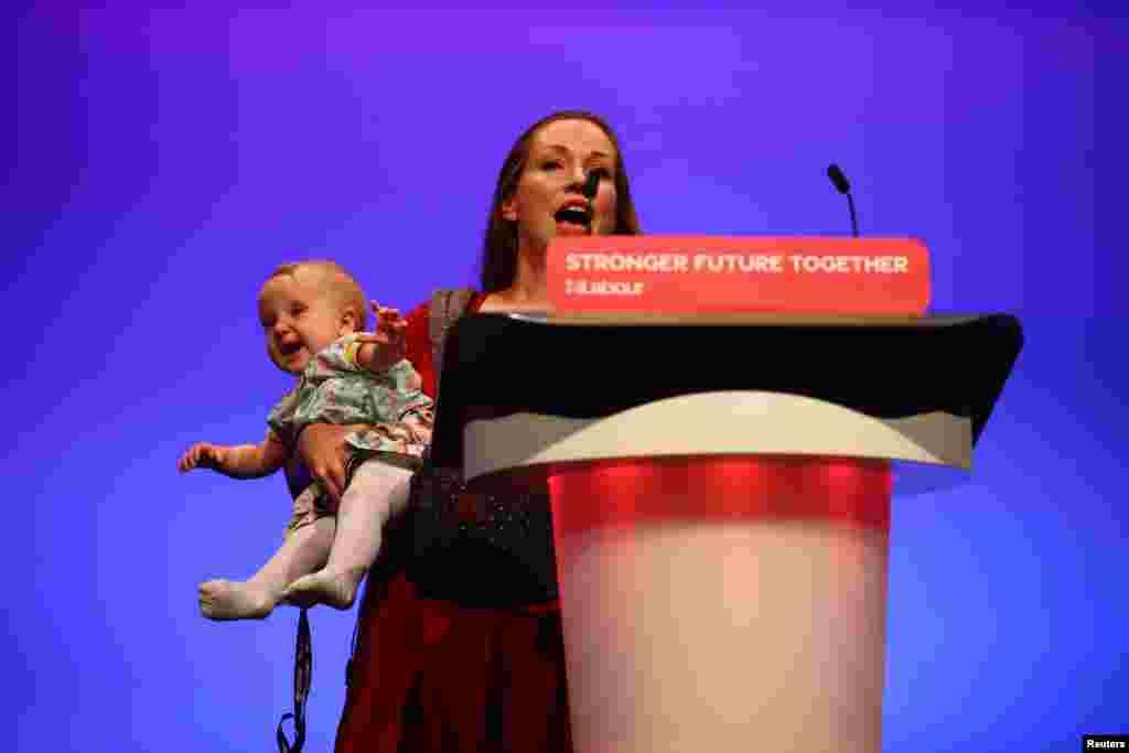 Delegate Catherine Atkinson speaks as she carries her 9-month-old Elena, during Britain&#39;s Labour Party annual conference in Brighton, Britain.