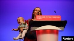 Delegate Catherine Atkinson speaks as she carries her 9-month-old Elena, during Britain&#39;s Labour Party annual conference in Brighton, Britain.
