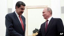 Russian President Vladimir Putin, right, shakes hands with Venezuela's President Nicolas Maduro during their meeting in the Kremlin in Moscow, Sept. 25, 2019. 