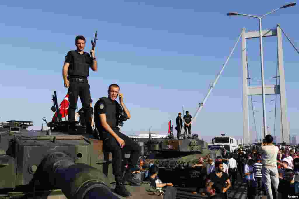 Policemen stand atop military armored vehicles after troops involved in the coup surrendered on the Bosphorus Bridge in Istanbul, Turkey July 16, 2016. REUTERS/Murad Sezer