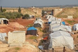 FILE - A makeshift refugee camp in Maaret Tamsrin, north of Idlib city, Syria, Feb. 19, 2020.