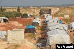 FILE - A makeshift refugee camp in Maaret Tamsrin, north of Idlib city, Syria, Feb. 19, 2020.