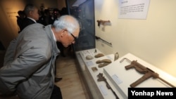 지난 12일 한국 국방부 유해발굴감식단과 대한민국역사박물관이 공동으로 개최한 6·25 전사자 유해발굴 특별전 '67년 만의 귀향'(Bring Them Home) 개막식에서 참석자들이 전사자들이 썼던 유품을 보고 있다.