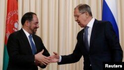 FILE - Russian Foreign Minister Sergei Lavrov and his Afghan counterpart, Salahuddin Rabbani, shake hands during a joint news conference following their meeting in Moscow, Feb. 7, 2017. 