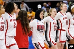 North Carolina State University's Jannah Eissa, middle, celebrates with her team after defeating the University of Tennessee in a second-round college basketball game in the NCAA Tournament in Raleigh, North Carolina, March 25, 2024.