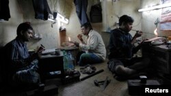 Goldsmiths work on gold ornaments at a workshop in India, Jan. 6, 2014. A new UN report finds widening income disparities in countries like India, which has seen significant levels of economic growth in recent decades.