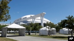 Tents are set up in a lot in front of the Marlins Park baseball stadium in preparation for a new drive through coronavirus testing site, March 23, 2020,in Miami.