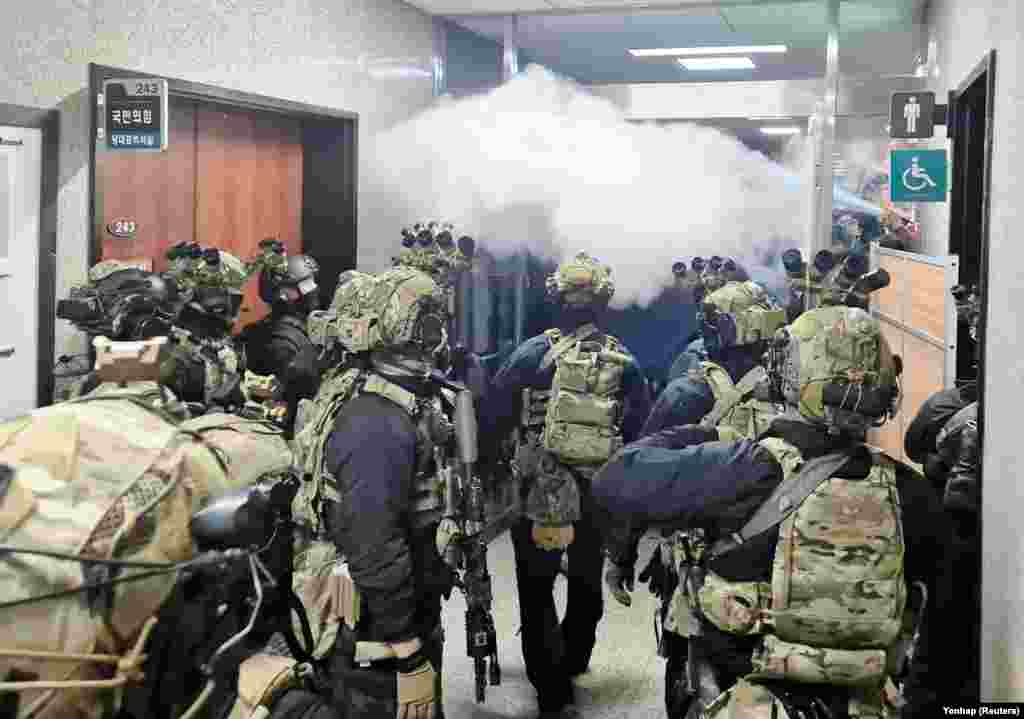 Soldiers advance to the main building of the National Assembly after South Korean President Yoon Suk Yeol declared martial law in Seoul, Dec. 3, 2024. (Yonhap via Reuters)