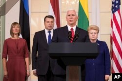 FILE - U.S. Vice President Mike Pence, second from right, accompanied by the leaders of Baltic states, from left, Estonian President Kersti Kaljulaid, Latvian President Raimonds Vejonis and Lithuanian President Dalia Grybauskaite, speaks during a news conference.