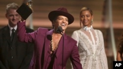 FILE - Bruno Mars accepts the award for record of the year for "Uptown Funk" at the 58th annual Grammy Awards in Los Angeles. 