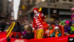  FILE - Ronald McDonald waves to the crowd during the Macy’s Thanksgiving Day Parade, in New York, on November 26, 2015. McDonald’s says Ronald McDonald is keeping a low profile with reports of creepy clown sightings on the rise.