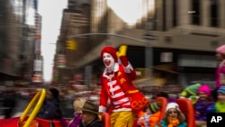 FILE - Ronald McDonald waves to the crowd during the Macy's Thanksgiving Day Parade, in New York, on November 26, 2015. McDonald’s says Ronald McDonald is keeping a low profile with reports of creepy clown sightings on the rise.