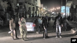 Free Syrian Army fighters guard a night protest in a neighborhood in Damascus, Syria, April 4, 2012.