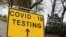 FILE - A sign is seen at the coronavirus disease (COVID-19) test centre at Stanley Park, near Anfield, on the first day of a newly imposed lockdown, in Liverpool, Britain, November 5, 2020.