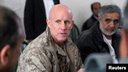 FILE - Vice Adm. Robert S. Harward, commanding officer of Combined Joint Interagency Task Force 435, speaks to an Afghan official during his visit to Zaranj, Afghanistan, in this Jan. 6, 2011. (Handout photo) 