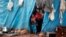 Displaced Syrian children look out from their tents at Kelbit refugee camp, near the Syrian-Turkish border, in Idlib province, Syria, Jan. 17, 2018. 