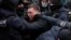 Law enforcement officers restrain a demonstrator during a rally of entrepreneurs and representatives of small businesses amid the COVID-19 outbreak in Kyiv, Ukraine.