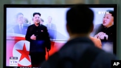 FILE - A man watches a TV news program showing North Korean leader Kim Jong Un using a cane during his first public appearance, at the Seoul Railway Station in Seoul, South Korea, Tuesday, Oct. 14, 2014.