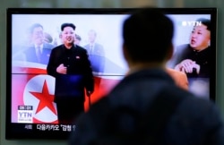 FILE - A man watches a TV news program showing North Korean leader Kim Jong Un using a cane during his first public appearance, at the Seoul Railway Station in Seoul, South Korea, Oct. 14, 2014.