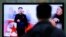 FILE - A man watches a TV news program showing North Korean leader Kim Jong Un using a cane during his first public appearance, at the Seoul Railway Station in Seoul, South Korea, Tuesday, Oct. 14, 2014.