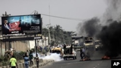 Police fire tear gas on protester on a major road in commercial capital during a fuel subsidy protest in Lagos, Nigeria, January 3, 2012.