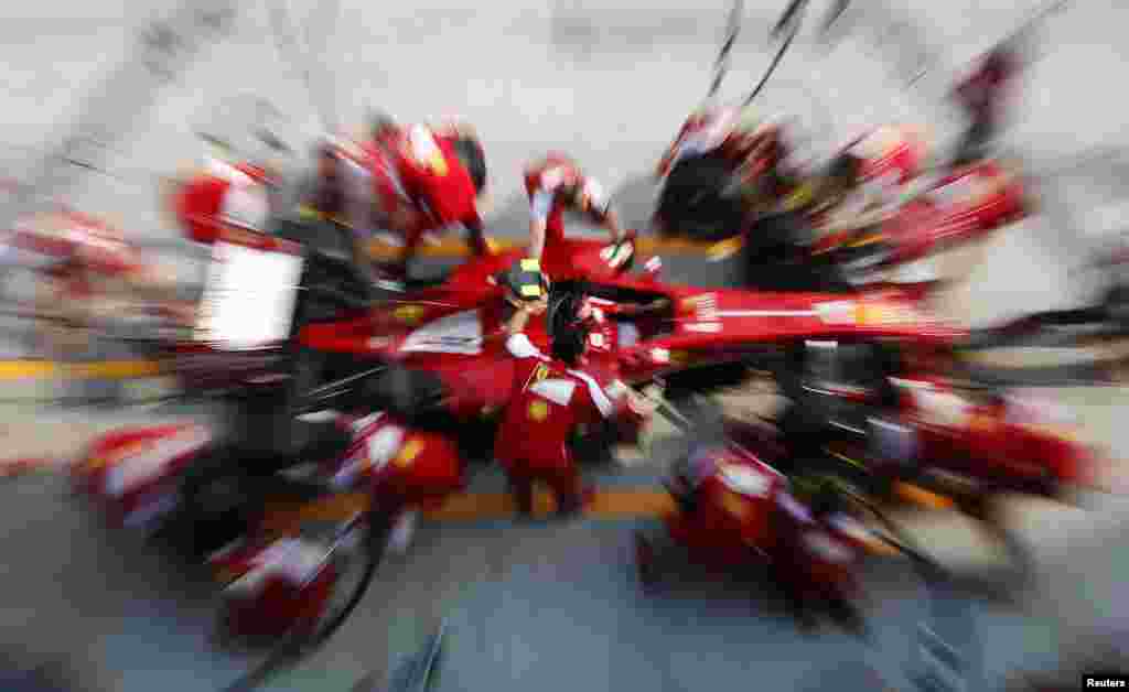 Ferrari Formula One pit crew practice pit stop with Felipe Massa&#39;s car at the Sepang International Circuit, ahead of the Malaysian F1 Grand Prix.