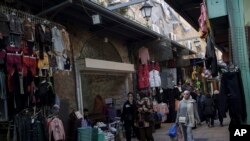 File—Muslim women walk through a market, ahead of the holy Islamic month of Ramadan, in the Old City of Jerusalem, Thursday, March 7, 2024.