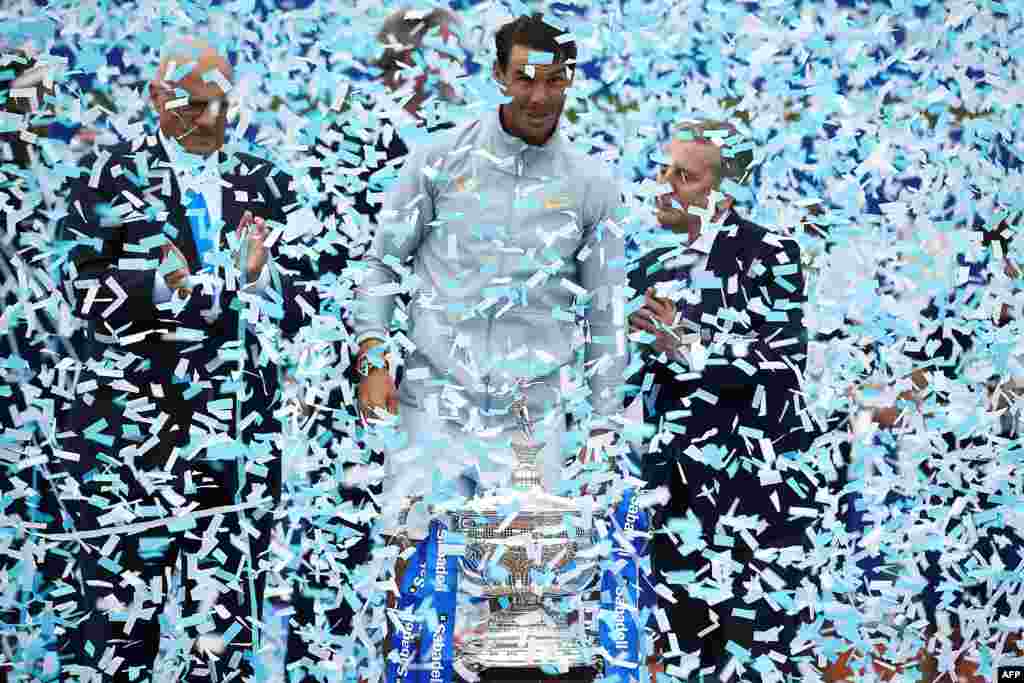 Confetti falls on Spain&#39;s Rafael Nadal as he celebrates with his trophy after winning the Barcelona Open ATP tournament final tennis match in Barcelona, Spain.