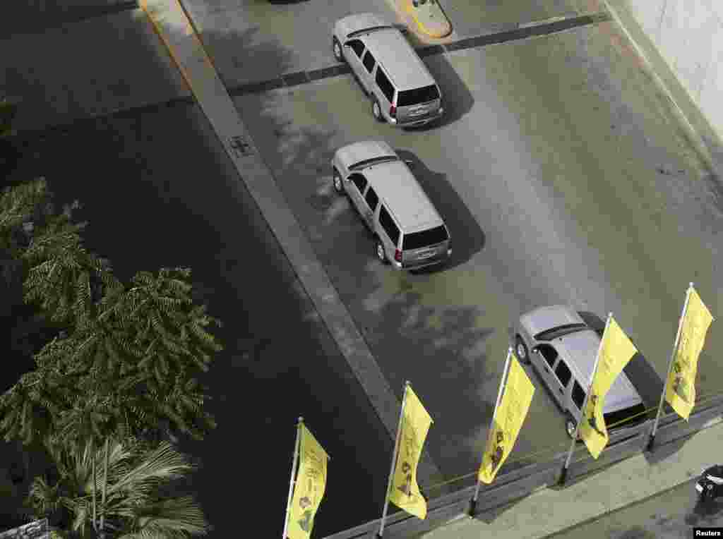 Hezbollah flags flutter as convoy of U.S. Secretary of State John Kerry crosses a Hezbollah-controlled area, Beirut, June 4, 2014.