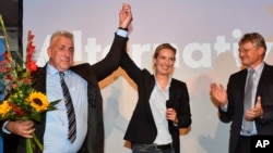 AfD top candidate Alice Weidel, center, gets flowers during the election party of the nationalist 'Alternative for Germany', AfD, in Berlin, Germany, Sept. 24, 2017.