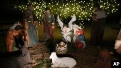 A Nativity scene is illuminated by a Christmas tree on Payrow Plaza in Bethlehem, Pennsylvania, known as 'Christmas City, USA,' Dec. 1, 2024.