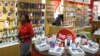 A worker walks past cell phone accessories at a Vodacom shop in Johannesburg, Feb. 4, 2015. 