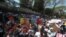 Anti-coup protesters gather outside U.S. Embassy in Yangon, Myanmar, Sat. Feb. 13, 2021.
