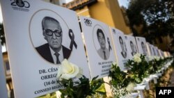 FILE - Images of the 125 doctors who have died during the COVID-19 pandemic in Peru are displayed outside Peru's Medical College (CMP) in Lima on Aug. 13, 2020. 