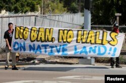 Immigrant rights advocates protest near the U.S.-Mexico border over a visit by U.S. Attorney General Jeff Sessions and Secretary of Homeland Security John Kelly in San Ysidro, a district of San Diego, California, April 21, 2017.